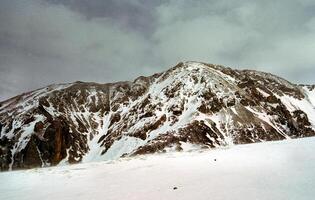Mount Sayan in winter in snow. The nature of the mountains is sayan. photo