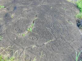 Stone slabs with drawings on Easter Island. Traces stone processing on plates. photo