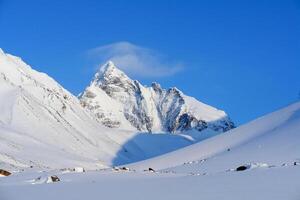 Baikal mountains in winter in snow. Forest in snow covered mountains. photo
