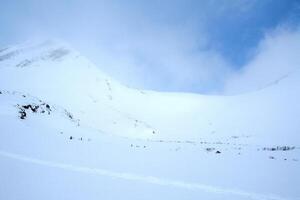 Baikal mountains in winter in snow. Forest in snow covered mountains. photo