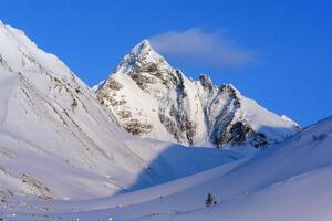 Baikal mountains in winter in snow. Forest in snow covered mountains. photo