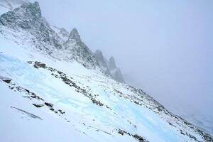 Baikal mountains in winter in snow. Forest in snow covered mountains. photo
