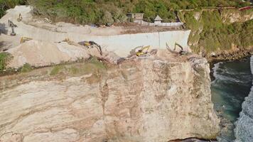 Escalators digging the rock on cliff coastline near Uluwatu temple. Drone view video