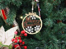 A christmas tree decorated with a merry christmas ornament photo