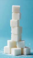 Sugar cubes stacked on a blue background create an abstract and simple structure for culinary presentations photo