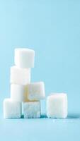 Stacked sugar cubes against a light blue background showcasing a simple yet elegant culinary composition photo