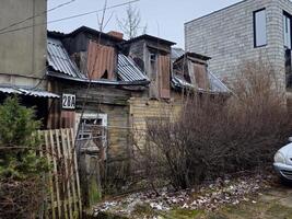 an old house with a car parked in front of it photo