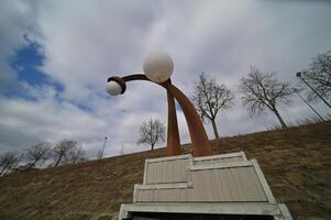 a sculpture of a man with a large white ball on his head photo
