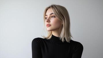 A contemplative moment of a young woman in a black turtleneck against a minimalistic backdrop photo