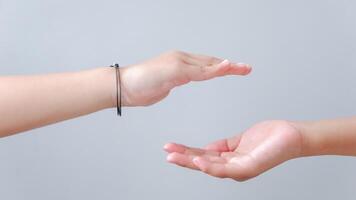 children hands reach toward each other isolated on gray. Small child's hand reaches for the hands friend. Helping hand concept, support. Helping hand outstretched. photo