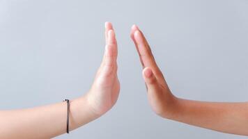 Two hands gestures. Giving high five. Two hands, male and man. High five gesture two girl, successful cooperation. High-five gesture and tenderness of friendship between schoolchild. photo