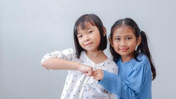 Fist Bump Friends Deal Partner Touch Pair Hands. Elementary students greet each other Trust in Team Giving Fist Bump to Greeting Say Hello or Say goodbye on weekends. photo