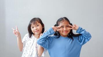 Photo of positive friendship hands palms girl fingers show v-sign have good mood isolated on grey color background