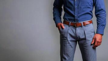 Stylish Man in Blue Shirt and Brown Belt Against Grey Background Copy Space photo