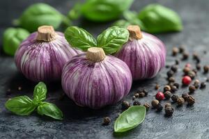 Fresh Purple Garlic with Basil and Peppercorns on Dark Slate photo