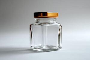 Empty square glass jar with golden lid on white background photo