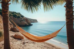 Hammock hanging between palm trees on tropical beach invites relaxation photo