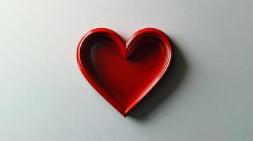 Red heart shape emerging from concentric layers on gray background photo