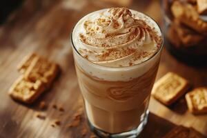 Iced coffee frappe topped with whipped cream and cinnamon enjoying with biscuits photo