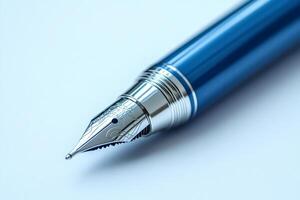 Close-up of elegant blue fountain pen nib resting on white surface photo