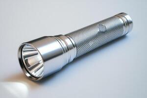 Chrome metal flashlight resting on white background photo
