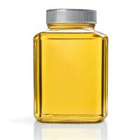 Clear glass container filled with golden liquid on a plain surface in a well-lit environment photo
