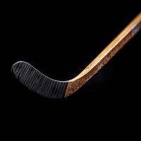 Close-up of a hockey stick showing blade details against a dark background photo