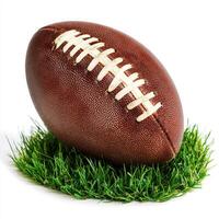 Classic brown football resting on lush green grass, perfect for a game on a sunny day photo