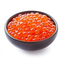 Colorful salmon roe displayed in a dark bowl, showcasing a rich texture and vibrant appearance photo