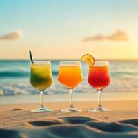 Colorful cocktails on a beach at sunset with gentle waves in the background photo