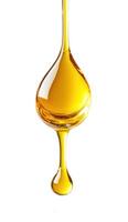 Golden liquid drips from a spoon highlighting smooth texture and vibrant color in a minimalist setting photo