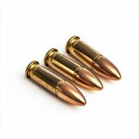 Three brass bullets arranged orderly on a plain background showcasing their metallic finish and pointed tips photo