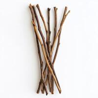 Sticks arranged on a bright white surface for natural decor or crafting projects photo