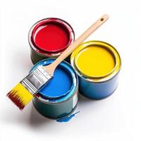Several cans of paint with vibrant colors and a paintbrush on a white background ready for a creative project photo