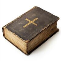 Old leather-bound Bible book with cross symbol resting on a surface, showing wear and age photo