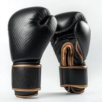 Boxing gloves designed for training and competition with a sleek black and gold finish photo