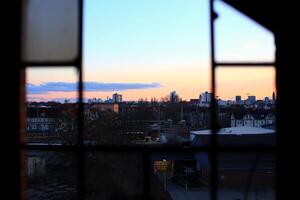 View through ruined window with missing panes in the middle of the city of Magdeburg, Germany photo