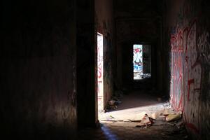 Dark and spooky hallway in a ruined building photo
