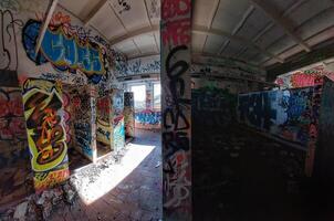 Abandoned bathrooms with partition wall creating a bright and a dark area photo
