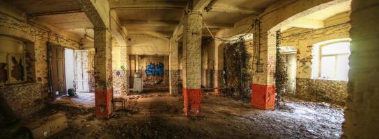 Interior of an abandoned storage building with gate and window photo