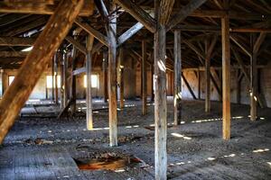Old and dirty attic with bright daylight coming from outside photo