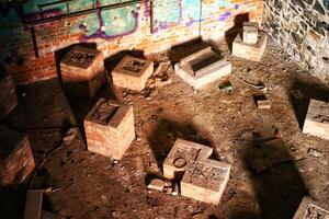 Brickwork bases for several industrial devices in an abandoned factory photo