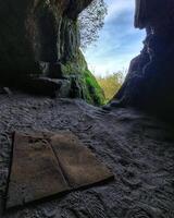 Cave with a simple mat used as a retreat for meditation photo