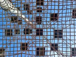 Upward view through the safety net of a climbing playground photo