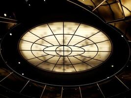 Conceptual high contrast shot of oval lighting at the ceiling photo