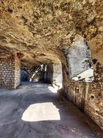 Sunlight falling into underground vault made of rocks photo