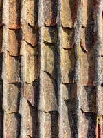Texture of an old roof with traditional tiling technique photo