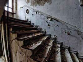 Noisy image of desolate staircase in an abandoned building photo