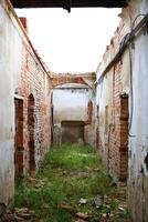 View through corridor of an abandoned building without roof photo