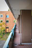 Stained balustrade in front of a row of apartments photo